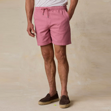Load image into Gallery viewer, Person wearing light red shorts on a beige background