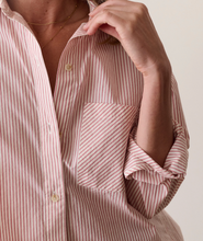 Load image into Gallery viewer, Close-up of a person wearing a pink and white vertically striped button-down shirt with rolled-up sleeves and a chest pocket.