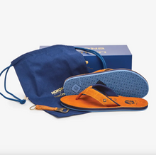 Load image into Gallery viewer, Brown leather sandals with blue soles, shown with a blue drawstring bag, box, and bottle opener keychain