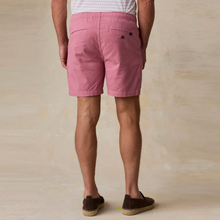 Load image into Gallery viewer, Back view of a person wearing light red shorts on a beige background
