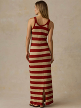 Load image into Gallery viewer, A woman wearing a sleeveless, floor-length striped dress with horizontal red and beige stripes, shown from the back against a textured beige studio backdrop.
