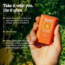 Load image into Gallery viewer, Hand holding a Sunsiki sunscreen stick with outdoor background
