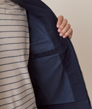 Load image into Gallery viewer, Closeup detail of the inside pocket of a navy jacket
