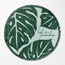 Load image into Gallery viewer, Round green and white leaf-patterned beach towel with 'lost in paradise' text on a white background
