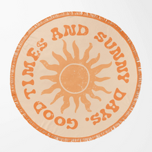 Load image into Gallery viewer, A round beach towel with fringe edges, featuring a distressed orange sun design and the text 'GOOD TIMES AND SUNNY DAYS' on a light beige background.
