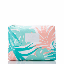 Load image into Gallery viewer, A rectangular zippered pouch featuring a tropical palm leaf pattern in teal, coral pink, and white, with a white brand label on the front.
