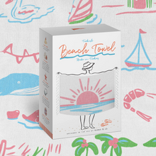 Load image into Gallery viewer, A boxed beach towel set displayed upright on a patterned fabric background. The box is white with colorful illustrated text reading 'Turkish Beach Towel Made in Turkey' and a drawing of a person holding the towel at the beach.
