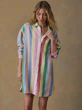 Load image into Gallery viewer, Woman wearing a colorful striped dress against a beige background
