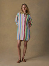 Load image into Gallery viewer, Woman wearing a colorful striped dress against a beige background
